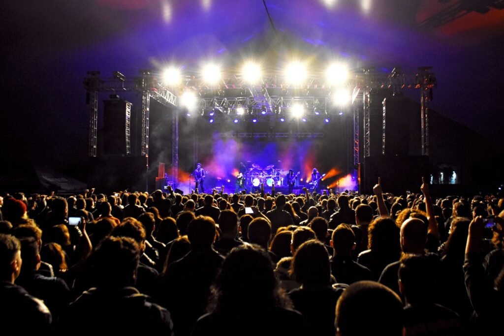 Concert stage lit up in front of a packed crowd