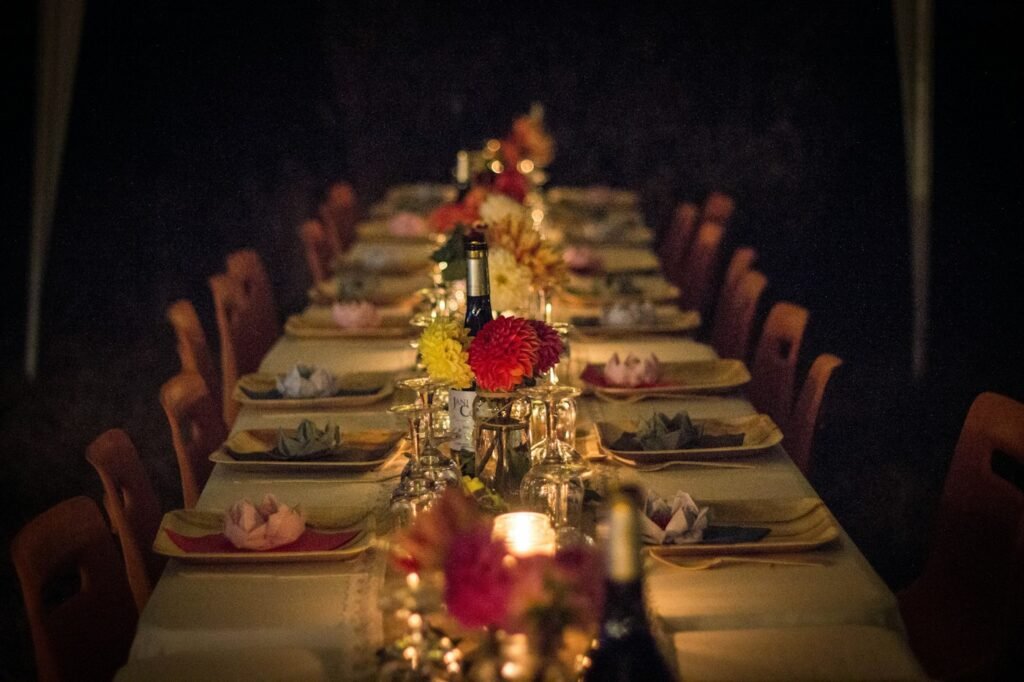 Long dinner table with flowers and candlelight