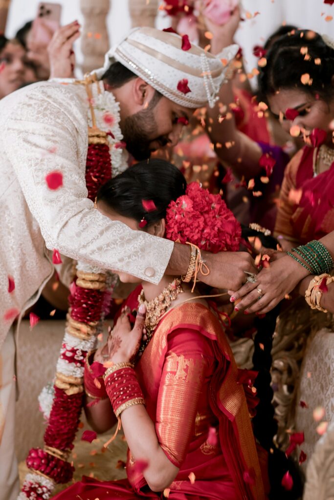 Couple showered with flower petals during a wedding ritual