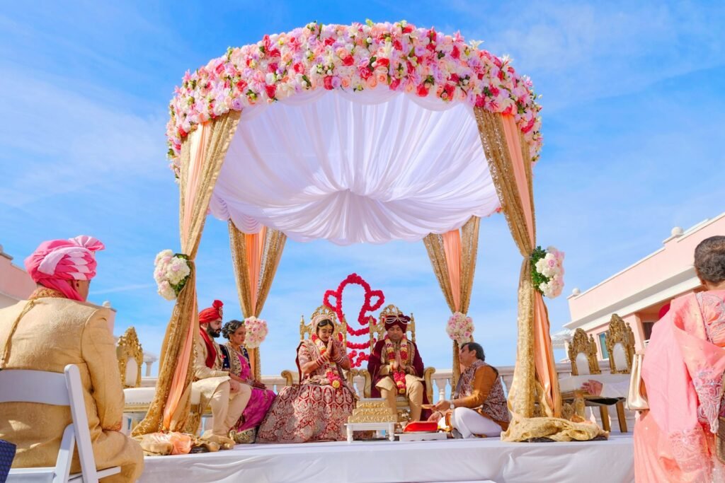 Open-air mandap ceremony under a floral canopy