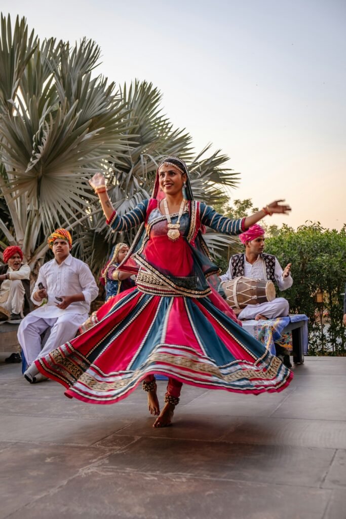 Dancer in a swirling lehenga with dhol players at a celebration